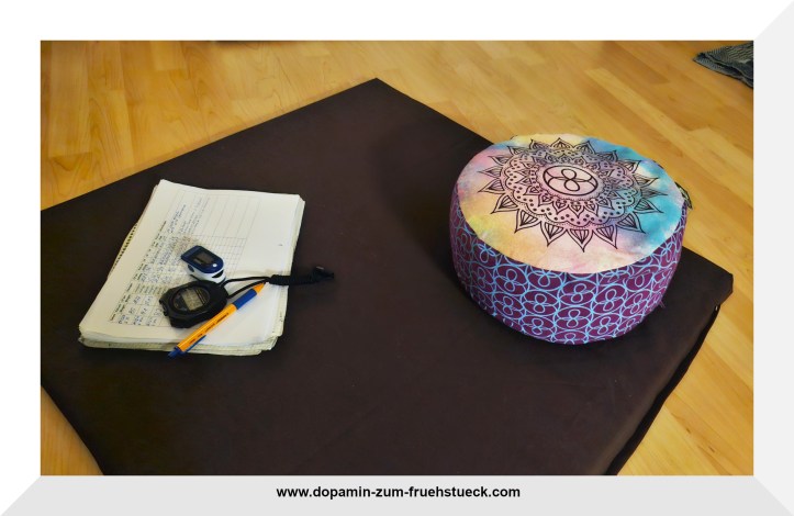 Meditationsmatte mit Meditationskissen und einem Block zum Schreiben